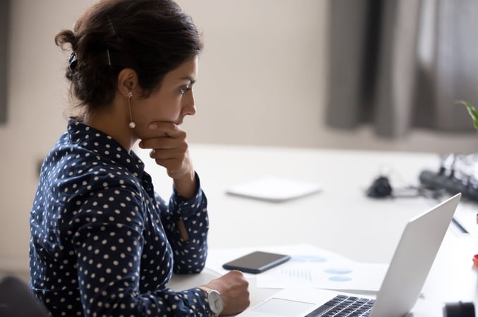 Woman Concentrating on Laptop